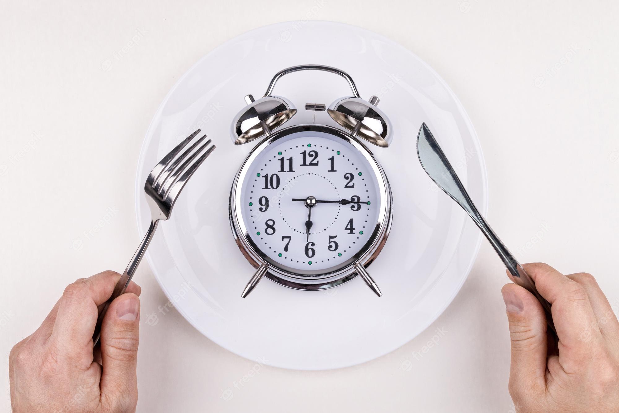 top view alarm clock white plate with knife fork white background intermittent fasting ketogenic diet weight loss meal plan healthy eating concept 739531 66